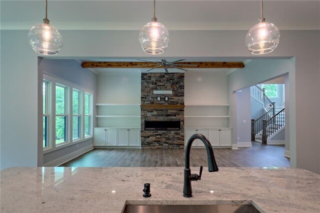 6449 Snelling Mill Rd, Flowery Branch, GA 30542 - kitchen with a sink, plenty of natural light, light stone counters, wood finished floors, and beam ceiling