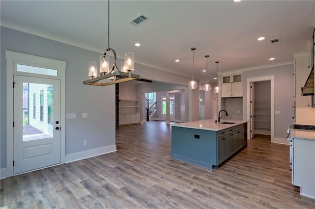 6449 Snelling Mill Rd, Flowery Branch, GA 30542 - kitchen with a sink, open floor plan, white cabinetry, crown molding, and baseboards