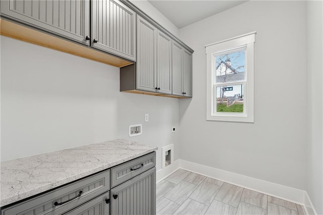 clothes washing area with electric dryer hookup, cabinets, and hookup for a washing machine