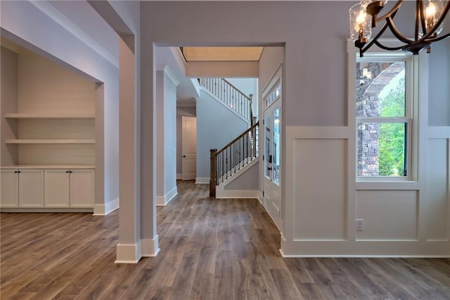 6449 Snelling Mill Rd, Flowery Branch, GA 30542 - entrance foyer with a chandelier, dark wood finished floors, stairway, and baseboards