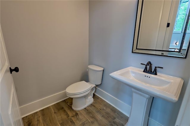 6449 Snelling Mill Rd, Flowery Branch, GA 30542 - half bath featuring toilet, wood finished floors, and baseboards