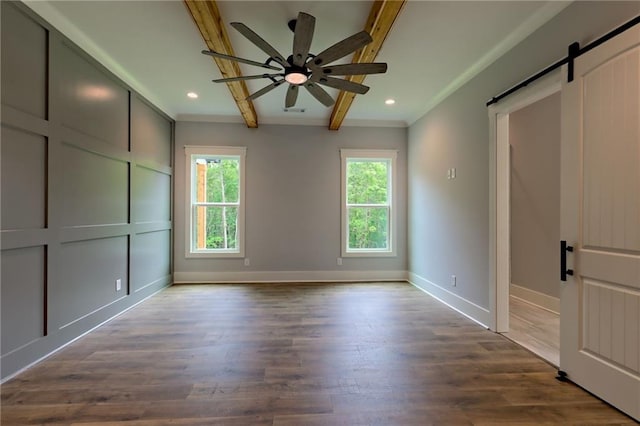 6449 Snelling Mill Rd, Flowery Branch, GA 30542 - unfurnished bedroom with a barn door, beam ceiling, multiple windows, baseboards, and dark wood-type flooring