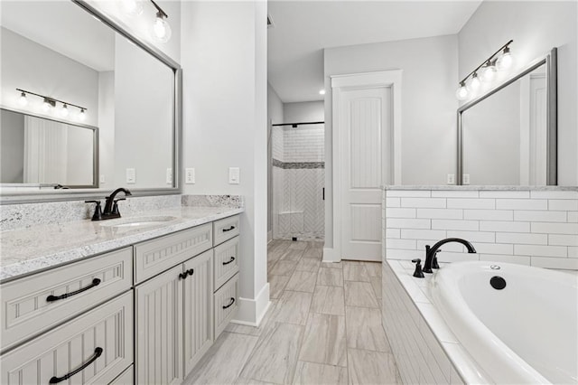 bathroom with vanity and separate shower and tub