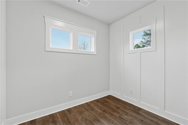 unfurnished room with dark hardwood / wood-style floors