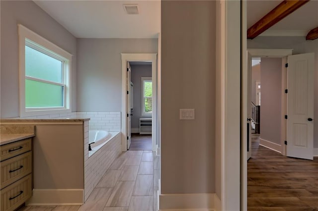 6449 Snelling Mill Rd, Flowery Branch, GA 30542 - bathroom with a bath, vanity, baseboards, and beamed ceiling