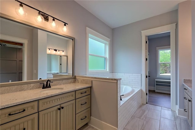 6449 Snelling Mill Rd, Flowery Branch, GA 30542 - bathroom featuring vanity, a garden tub, tile patterned floors, and baseboards