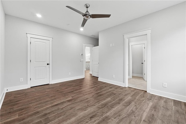 unfurnished bedroom featuring dark hardwood / wood-style flooring, ensuite bath, and ceiling fan