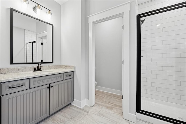 bathroom with vanity, toilet, and an enclosed shower