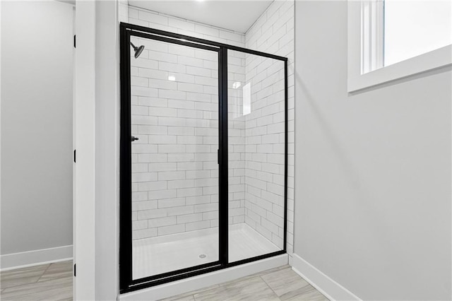 bathroom featuring a shower with shower door