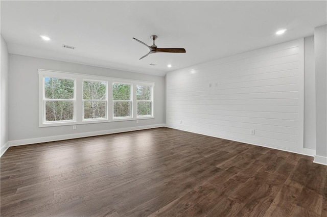 unfurnished room with dark hardwood / wood-style flooring and ceiling fan