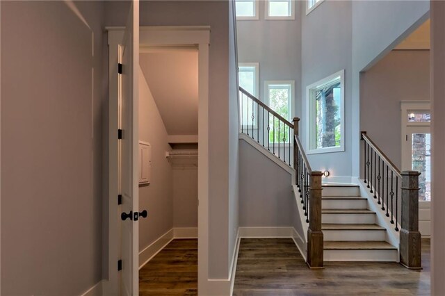 6449 Snelling Mill Rd, Flowery Branch, GA 30542 - stairs with plenty of natural light, wood finished floors, baseboards, and a towering ceiling