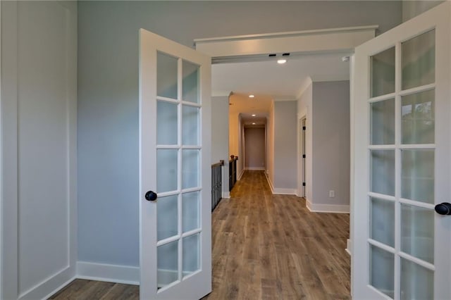 6449 Snelling Mill Rd, Flowery Branch, GA 30542 - hallway featuring wood finished floors, french doors, baseboards, and crown molding