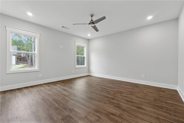 spare room with ceiling fan and dark hardwood / wood-style flooring