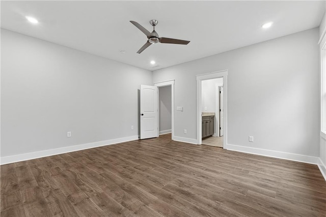 unfurnished bedroom featuring ensuite bathroom, ceiling fan, and dark hardwood / wood-style flooring