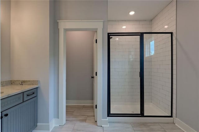 6449 Snelling Mill Rd, Flowery Branch, GA 30542 - full bathroom with a stall shower, vanity, and baseboards