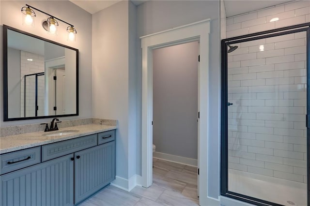 6449 Snelling Mill Rd, Flowery Branch, GA 30542 - bathroom with a stall shower, vanity, toilet, and baseboards