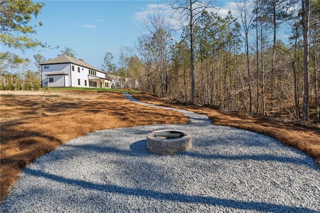 view of yard with a fire pit