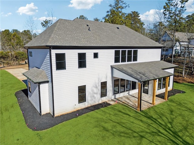 rear view of property with a lawn and a patio area