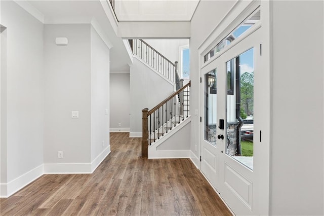 entrance foyer with hardwood / wood-style flooring and ornamental molding