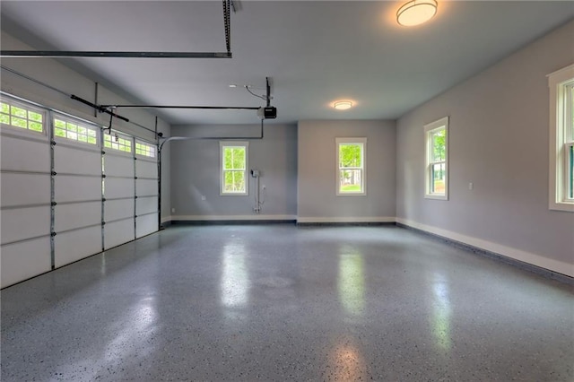 6449 Snelling Mill Rd, Flowery Branch, GA 30542 - garage featuring baseboards and a garage door opener