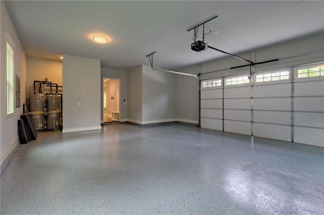 6449 Snelling Mill Rd, Flowery Branch, GA 30542 - garage with electric water heater, a garage door opener, and baseboards
