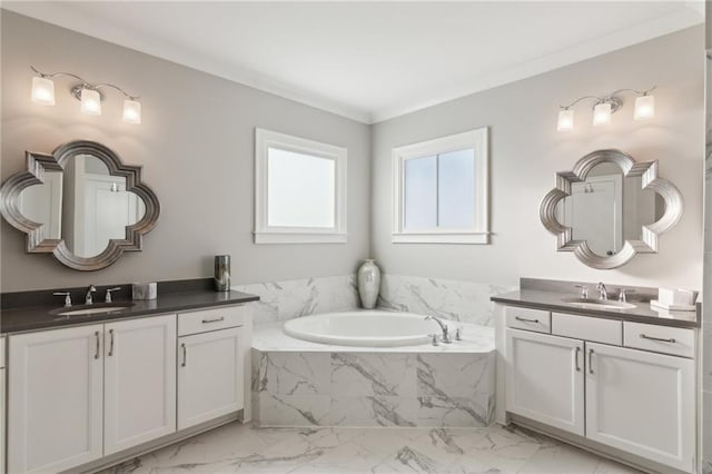 bathroom with crown molding, vanity, and tiled bath