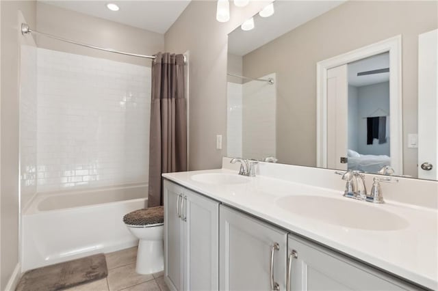 full bathroom with vanity, toilet, tile patterned flooring, and shower / bath combo