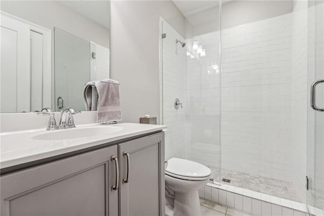 bathroom featuring vanity, an enclosed shower, and toilet