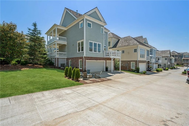 exterior space with a garage, a front lawn, and a balcony