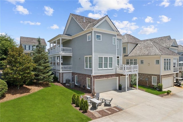 exterior space with a garage, a balcony, and a yard