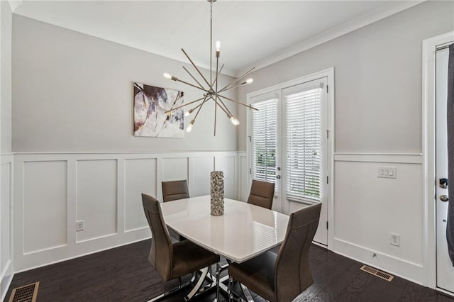 dining area with dark hardwood / wood-style floors and a chandelier