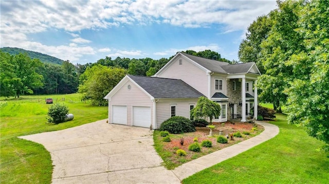 view of side of property with a garage and a lawn