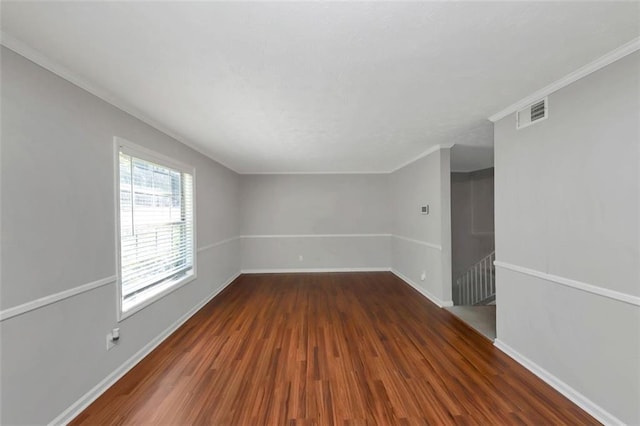 unfurnished room with crown molding and dark hardwood / wood-style flooring