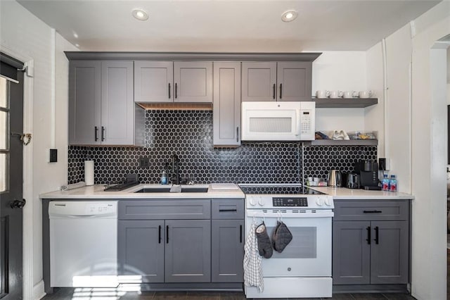 kitchen featuring white appliances, open shelves, a sink, and gray cabinetry