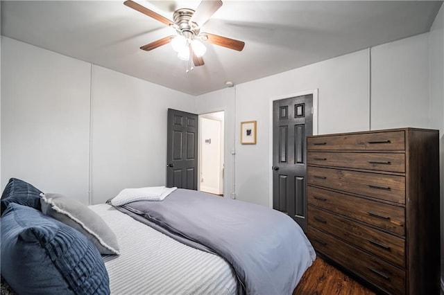 bedroom with ceiling fan and dark wood-type flooring