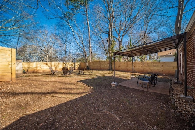 view of yard with a patio area and a fenced backyard