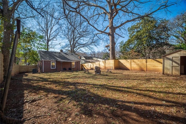 view of yard with an outbuilding and a fenced backyard