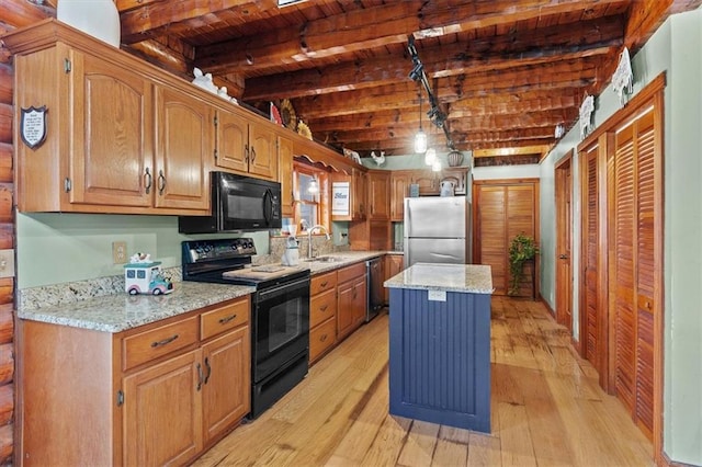 kitchen with beamed ceiling, black appliances, a kitchen island, wood ceiling, and light wood-type flooring