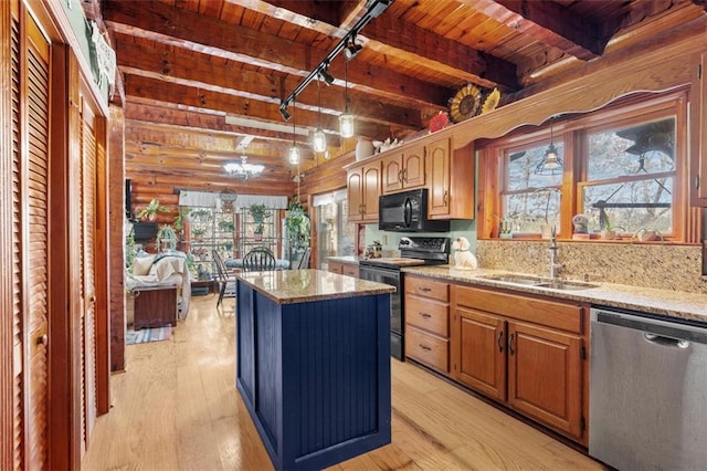 kitchen with sink, log walls, black appliances, light hardwood / wood-style flooring, and a kitchen island