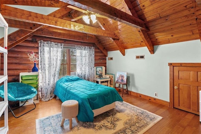 bedroom featuring ceiling fan, log walls, light hardwood / wood-style flooring, wooden ceiling, and vaulted ceiling with beams