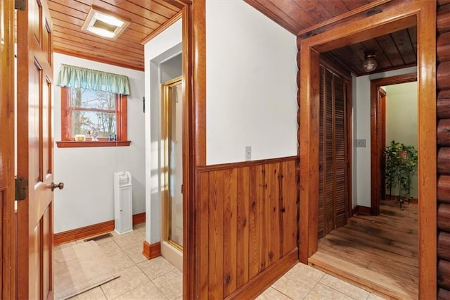 hall featuring wood walls and wooden ceiling