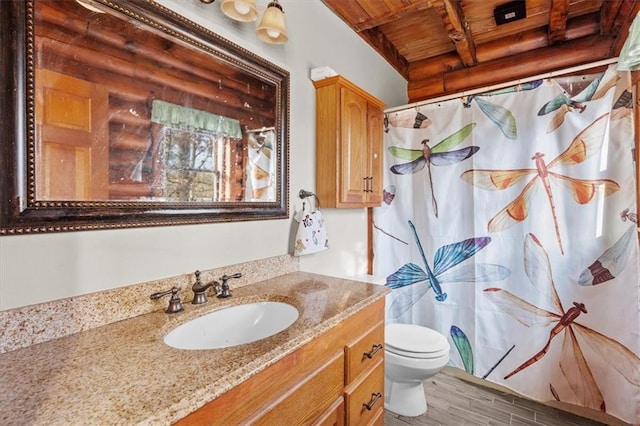 bathroom featuring beam ceiling, hardwood / wood-style floors, toilet, vanity, and wood ceiling