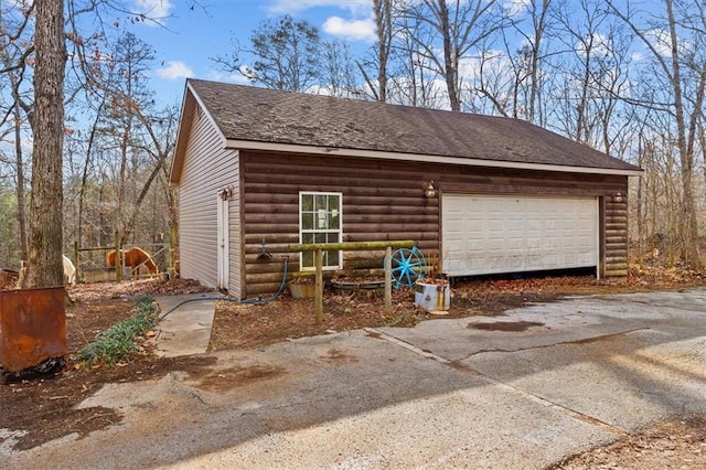 exterior space featuring a garage and an outdoor structure