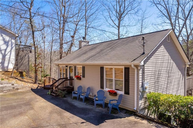 view of front of house with a patio and a chimney