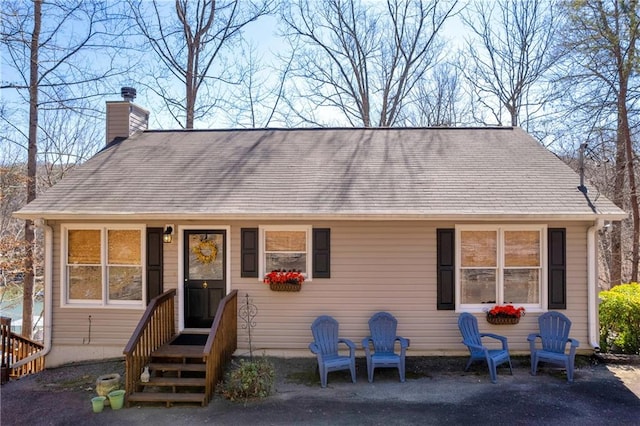 view of front of property with a patio and a chimney