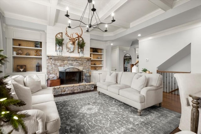 living room with hardwood / wood-style floors, built in features, beamed ceiling, coffered ceiling, and crown molding