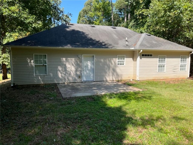 rear view of property with a patio and a yard