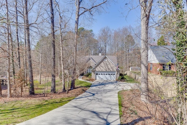 surrounding community featuring aphalt driveway and a garage