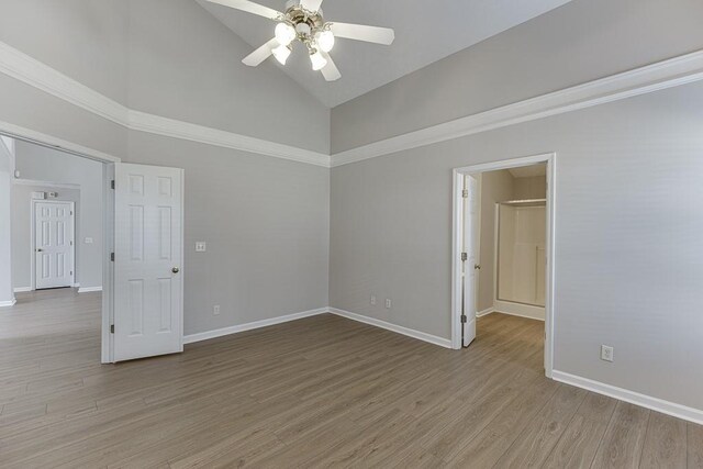 spare room with high vaulted ceiling, ceiling fan, baseboards, and light wood-style floors