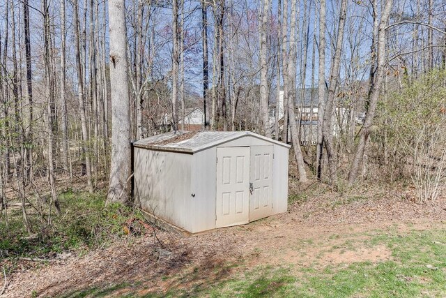 view of shed featuring a wooded view